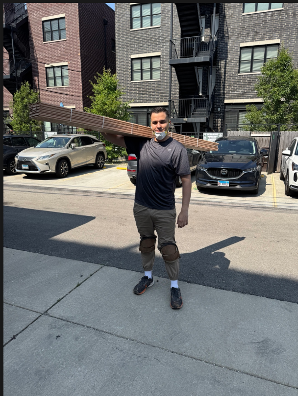Michael carrying hardwood flooring material
