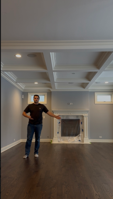 Michael standing in a finished hardwood flooring project